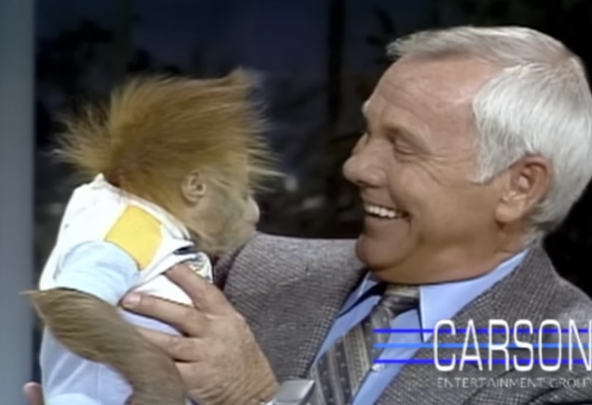 Carson cozies up to a baby gorilla from the San Diego Zoo. 